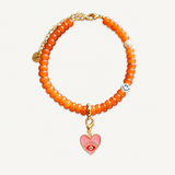 Orange beaded necklace with a pink heart charm on a white background