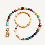 Colorful beaded leash with a gold clasp on a white background