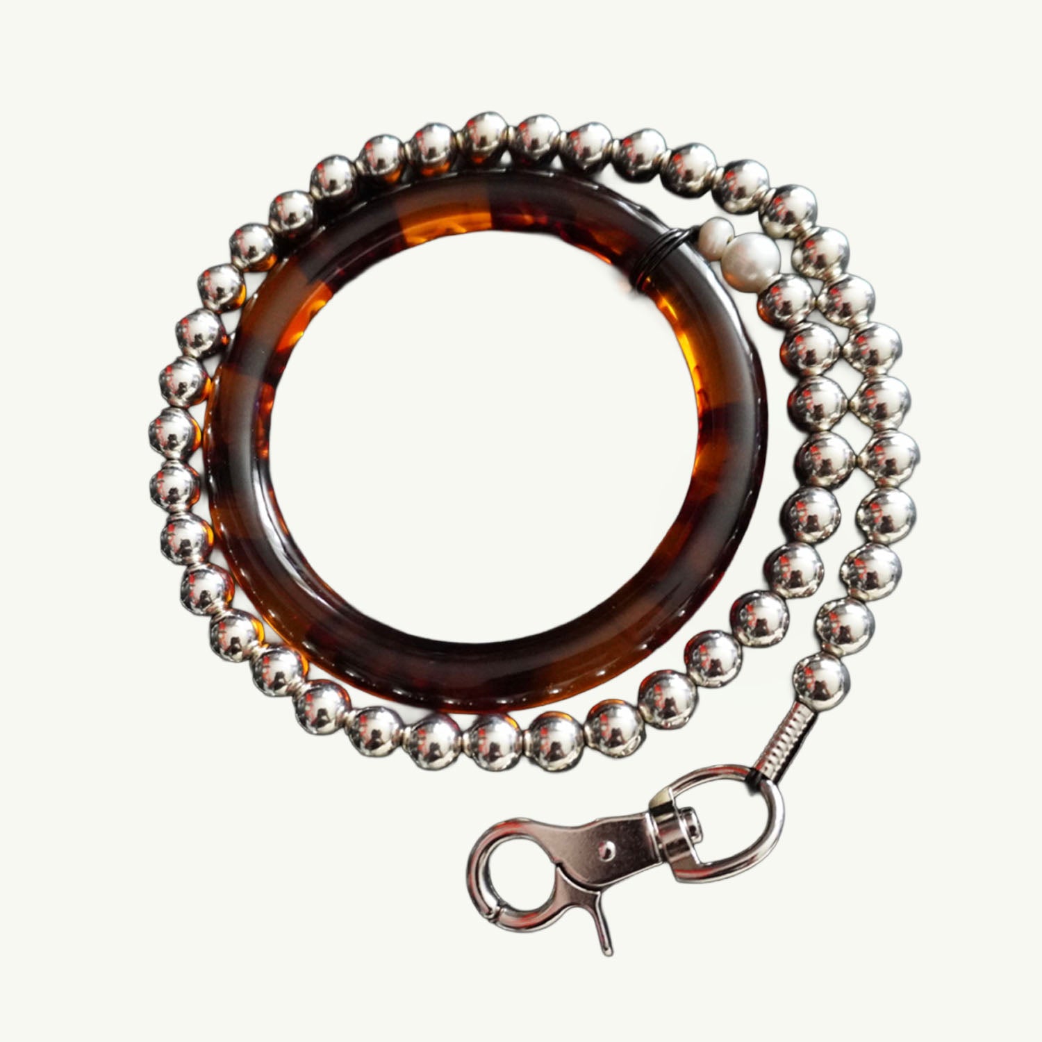 Tortoiseshell silver beaded leash on a white background