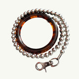 Tortoiseshell silver beaded leash on a white background