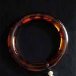 Tortoiseshell handle on a leather background
