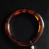 Tortoiseshell handle on a leather background